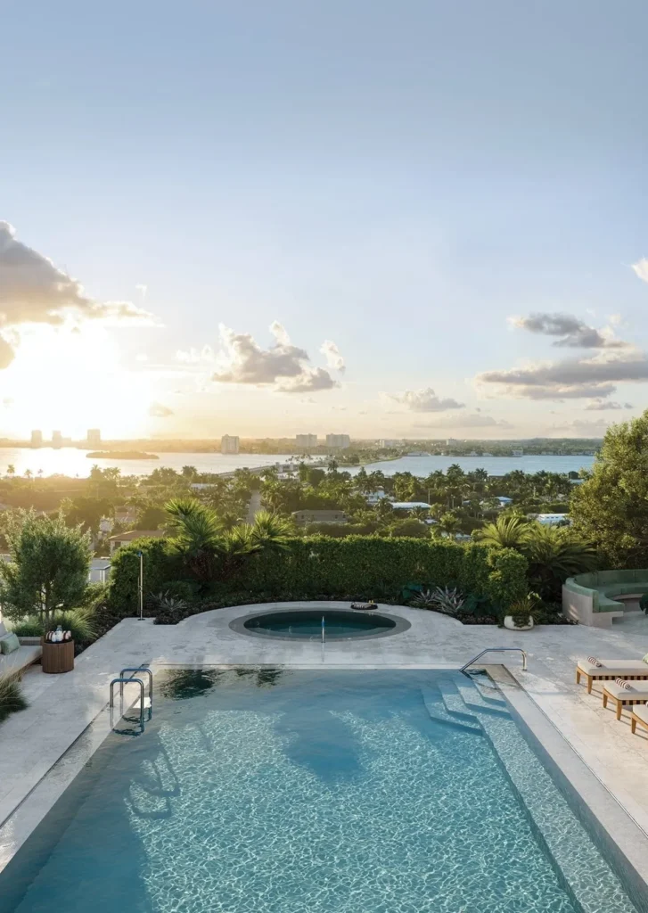Morning light over the bay beyond a pool deck