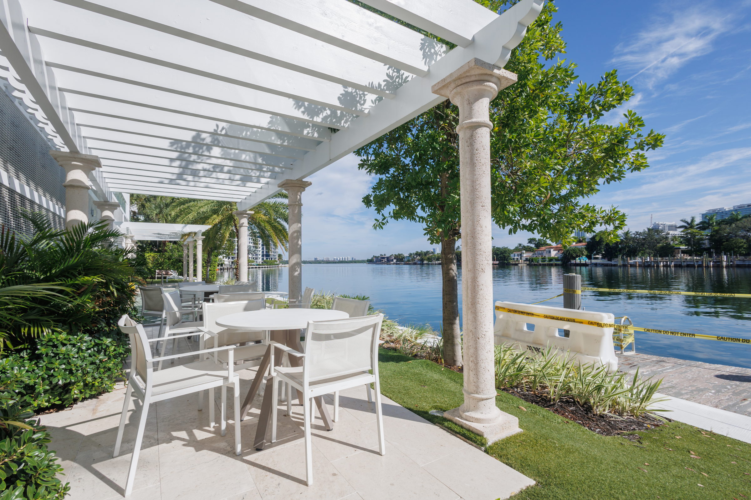 A table under the pergola looking over the water